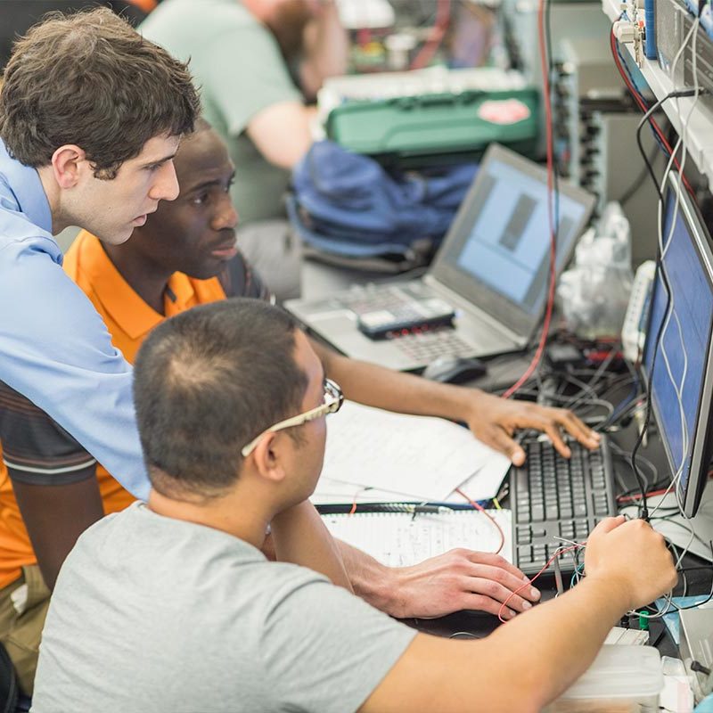 GRad Students work with faculty member in the Power Lab