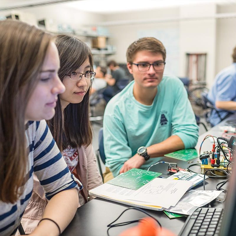 Three students work in the Power Lab