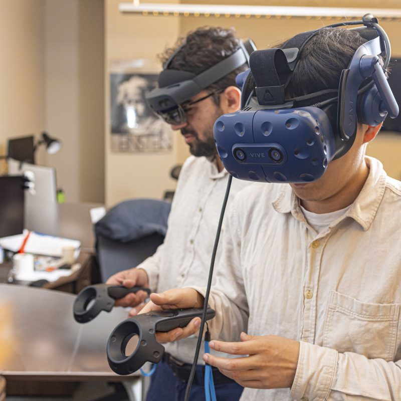 graduate students wearing virtual reality headsets