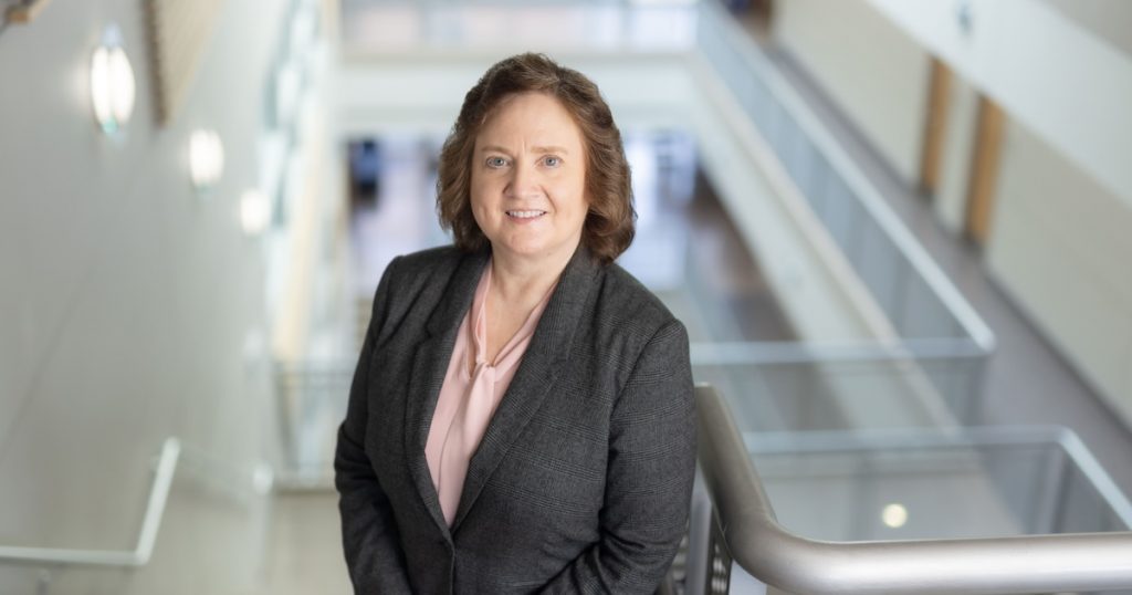 Lynne Parker standing in the hallway of a building