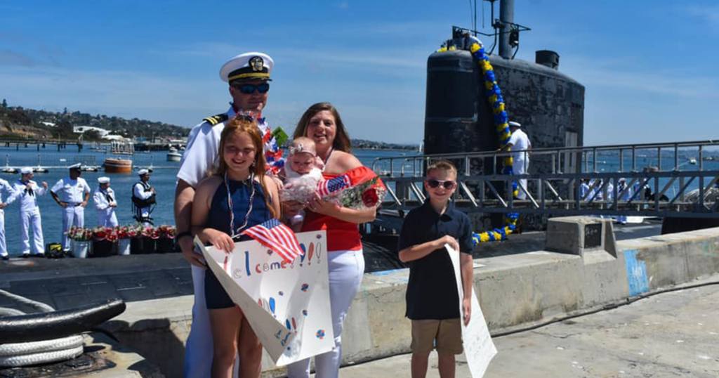 Frank Calicura, his wife, and three children as the family welcomes him home from deployment