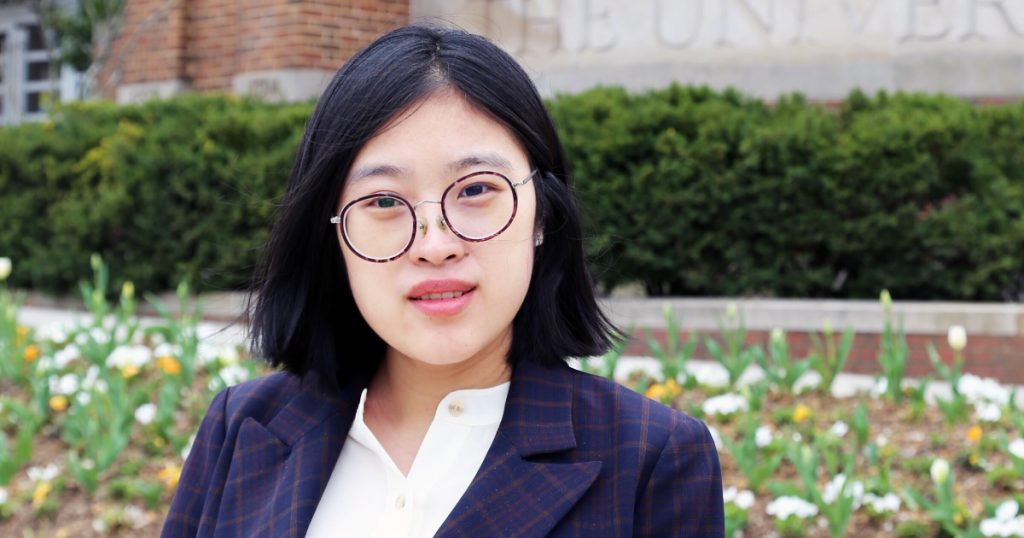 Yang Song standing in front of a University of Tennessee sign outside