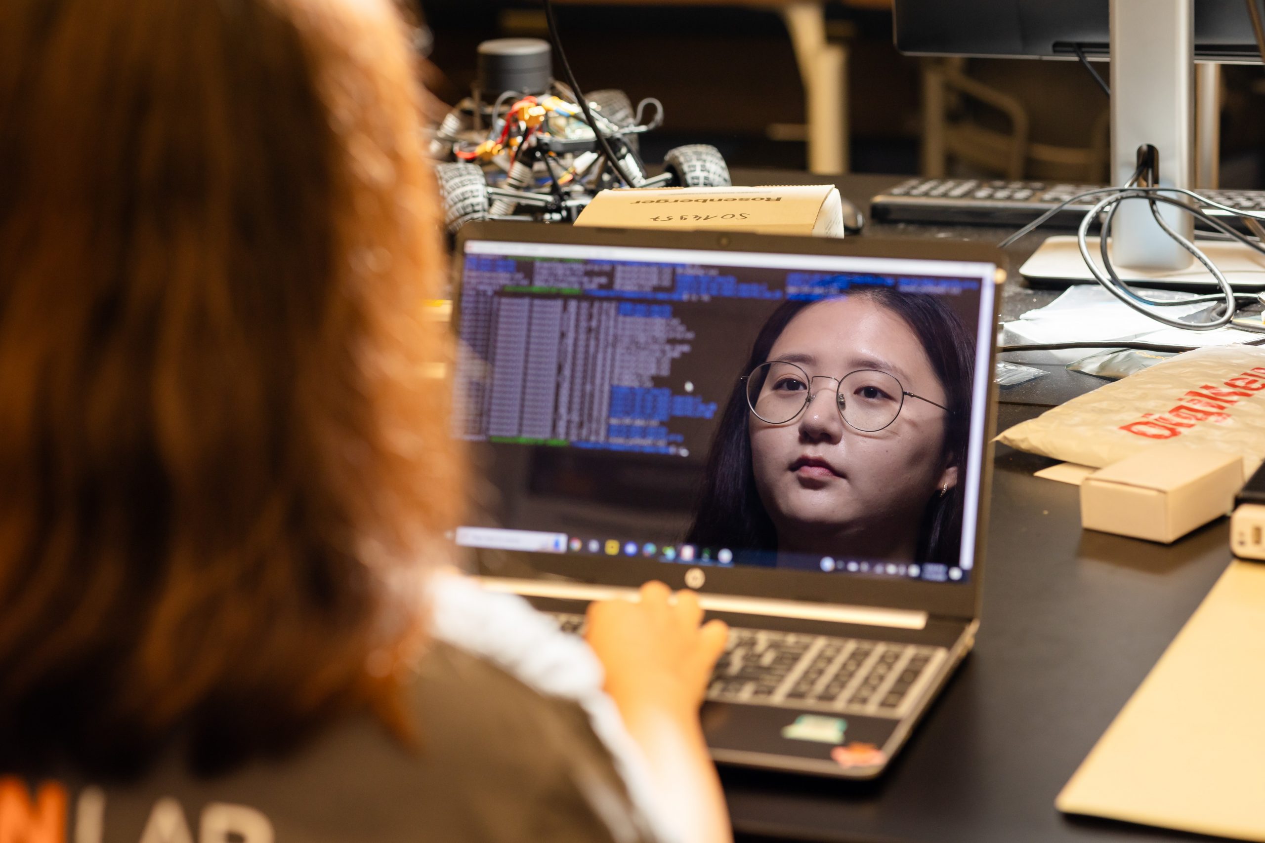 Amy An working on a project on a computer in a lab