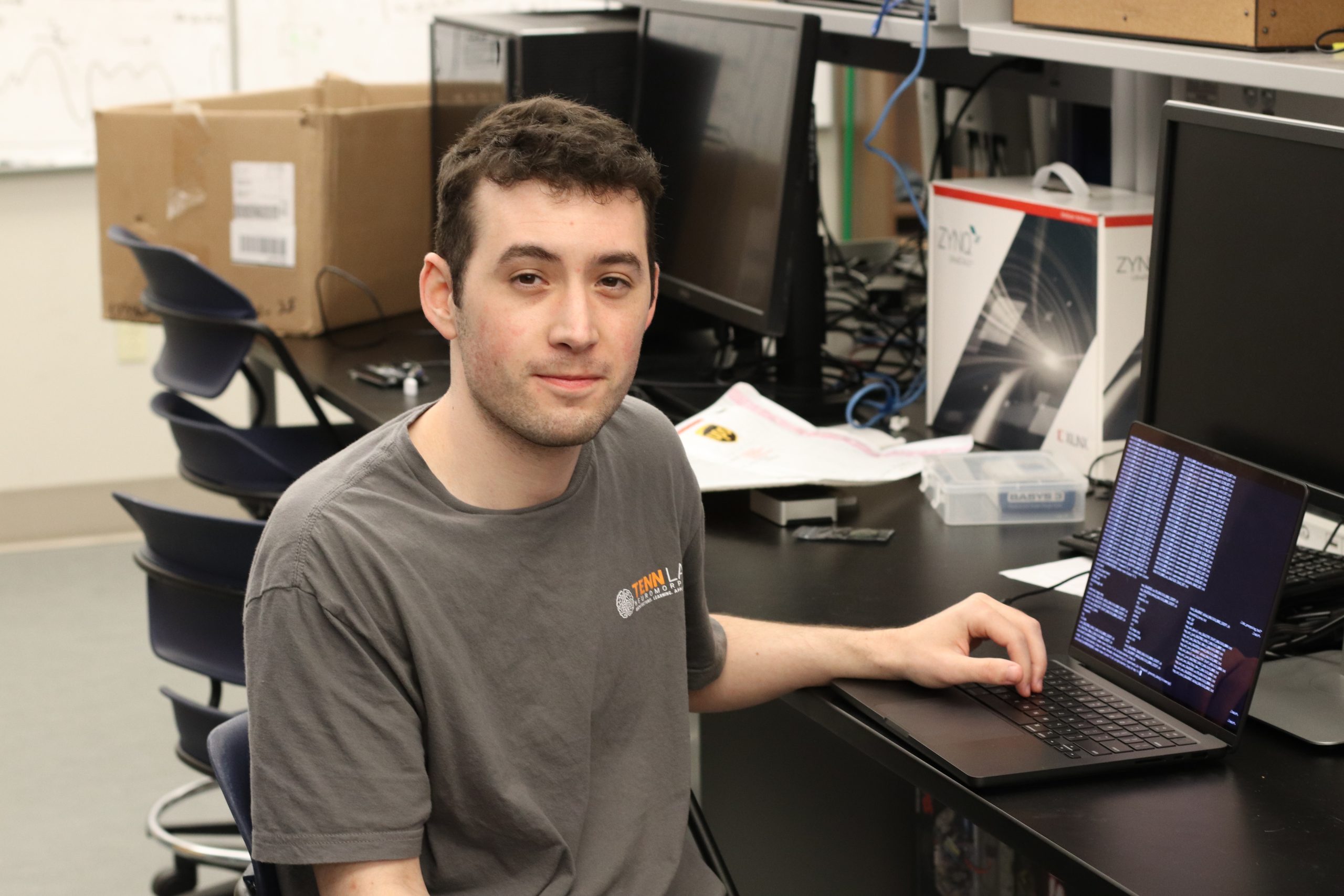 Daniel Mallett sitting in a computer lab