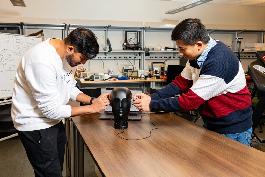 Jian Liu and Syed Irfan Ali Meerza setting up an electronic head