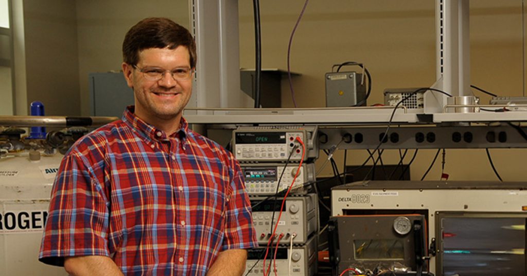 Ben Blalock standing in a lab