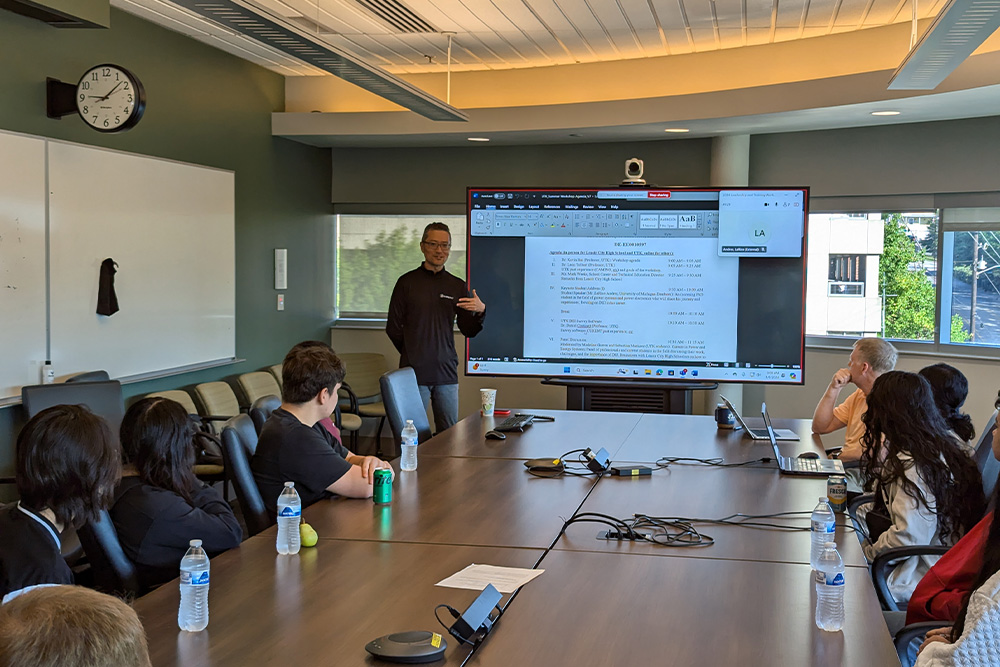 Kevin Bai teaching high school students in a conference room