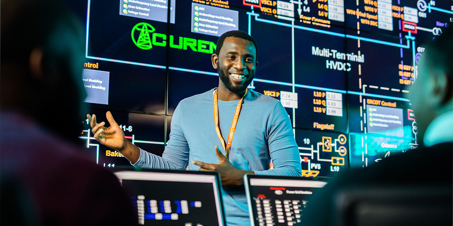 graduate student giving a presentation in the grid visualization lab