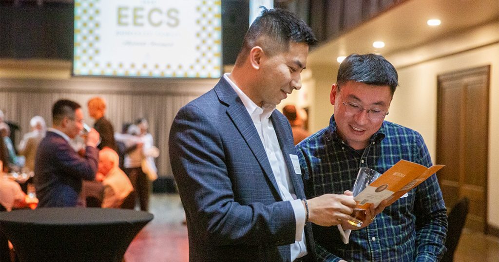Professors reading a pamphlet at the 2025 Gonzalez Awards