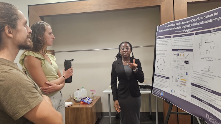 female student explaining her project to fellow students