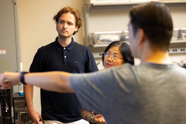 Hairong Qi and other faculty discussing a project