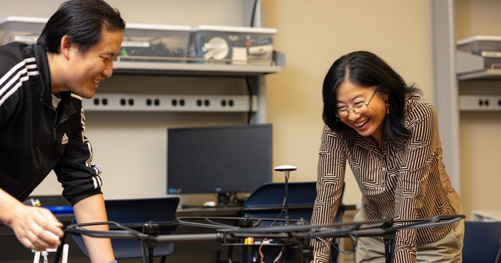 Hairong Qi and other faculty member working on a project