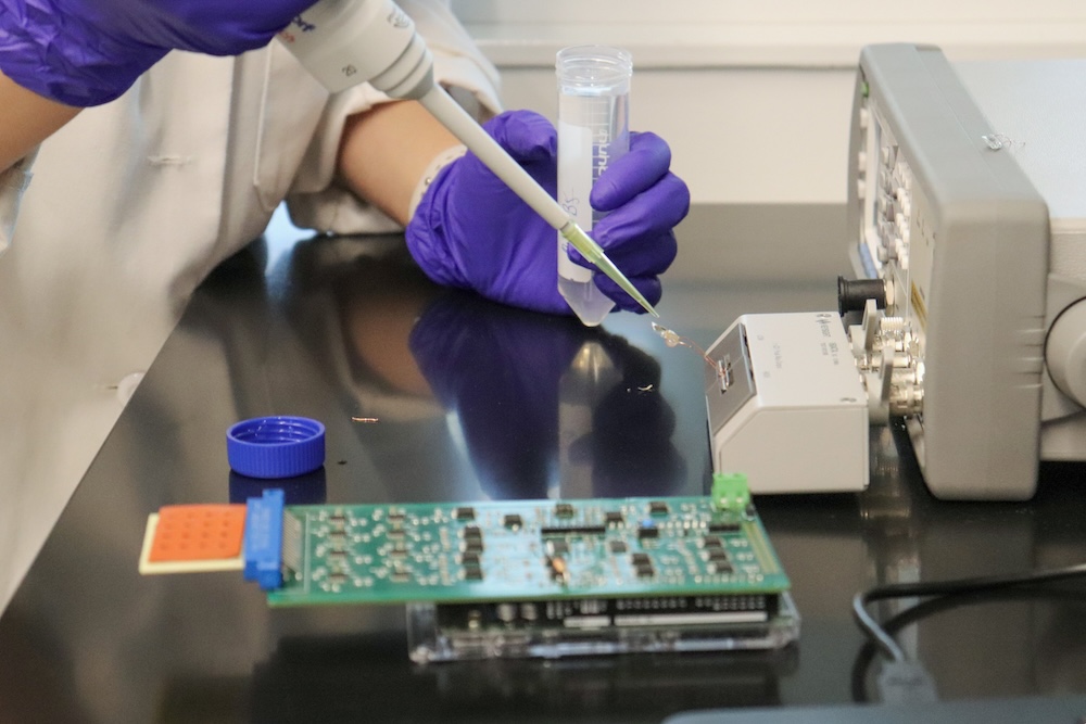 person working on the PTSD device in a lab