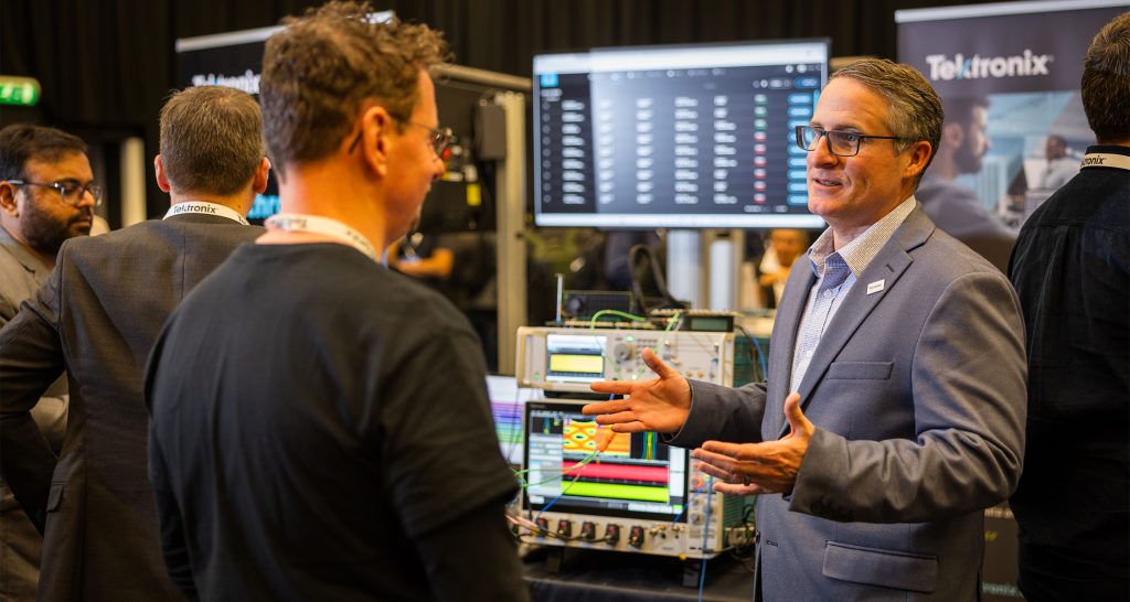 Rick Kuhlman speaking with someone at a conference