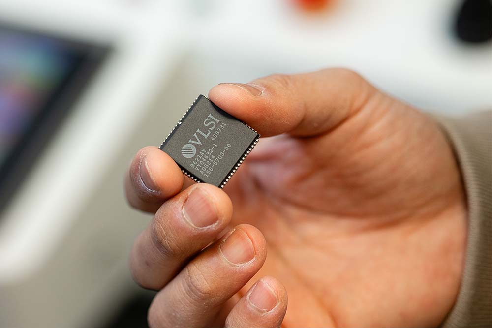 hand holding a computer chip