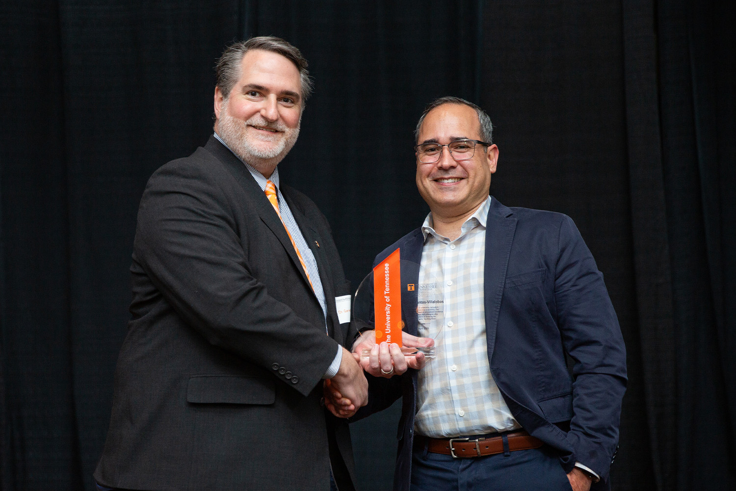 Garrett Rose and Hector Santos-Villalobos shaking hands at the Gonzalez Awards ceremony