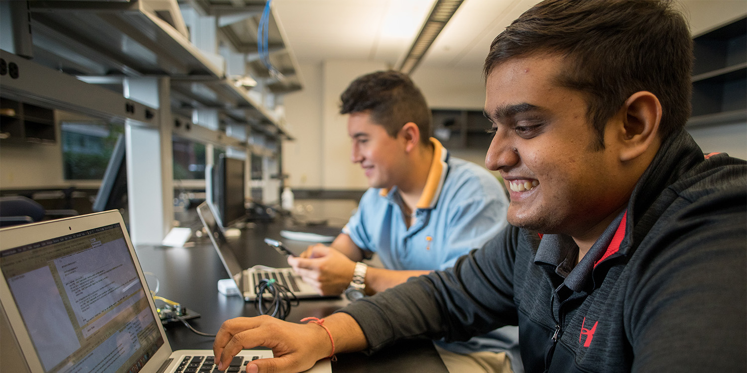 students working on projects in a lab on laptops