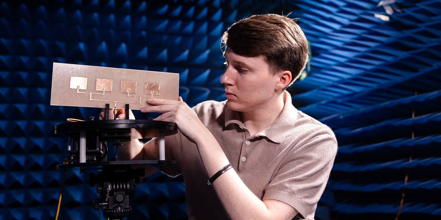 male student working in the anechoic chamber in the Min Kao Engineering lab