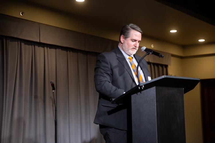 Garrett Rose speaking into a microphone at the 2025 Gonzalez Awards